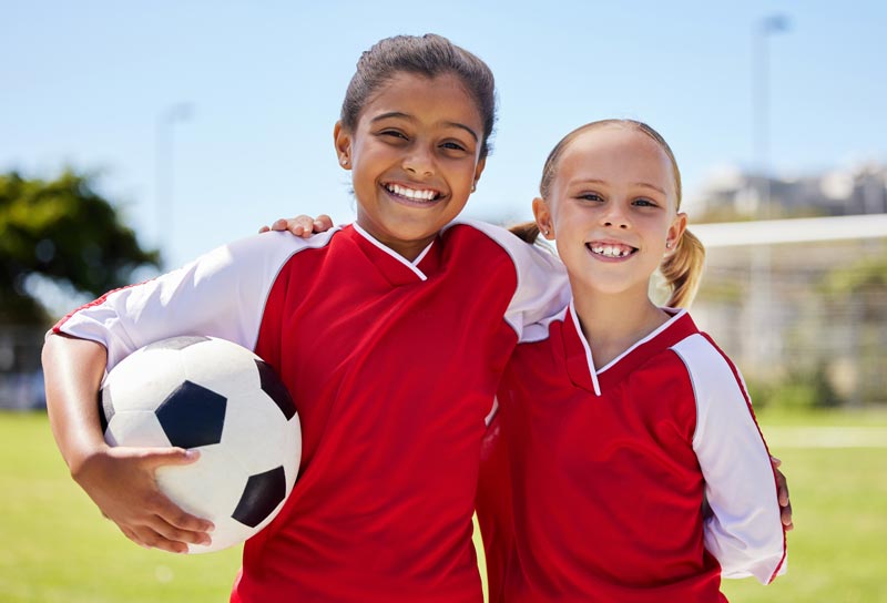 Kids posing with soccer ball